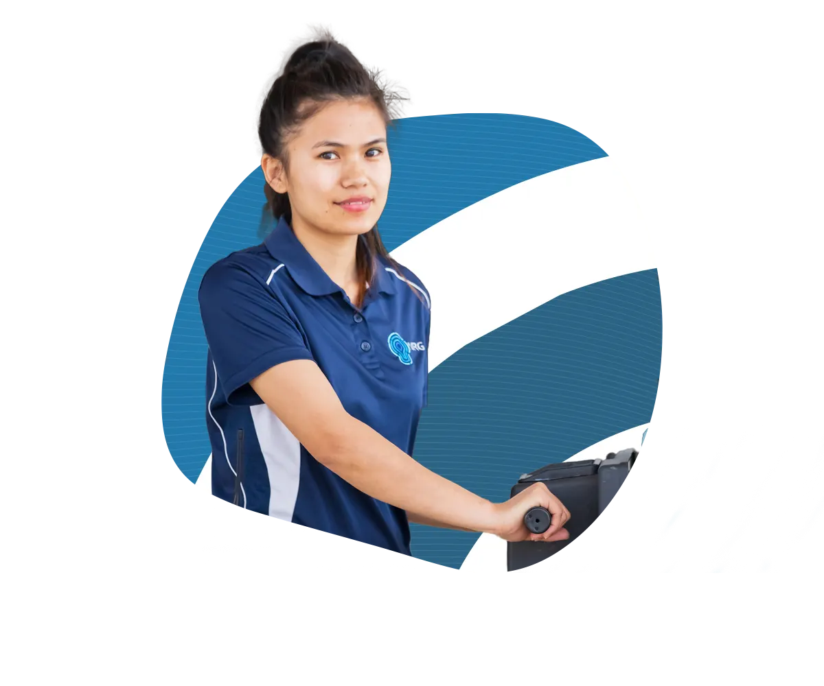 A woman in a blue and white uniform, representing NRG Cleaners, is using a black equipment device against a background with blue and white graphic elements.